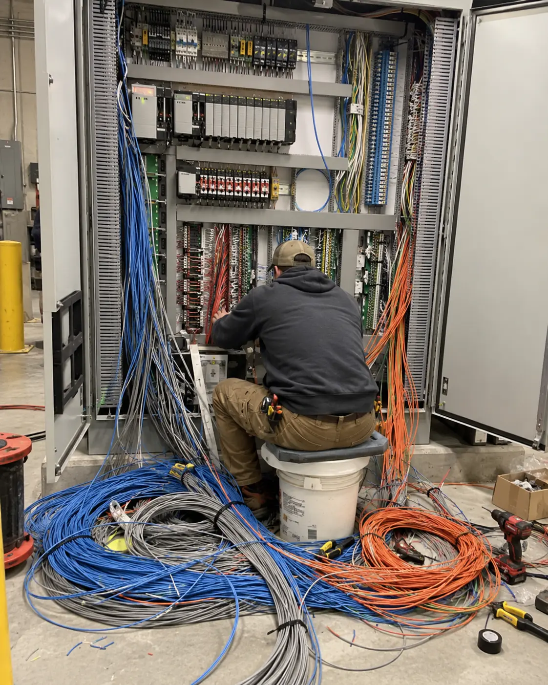 Commercial electrician working in an Ancaster industrial facility